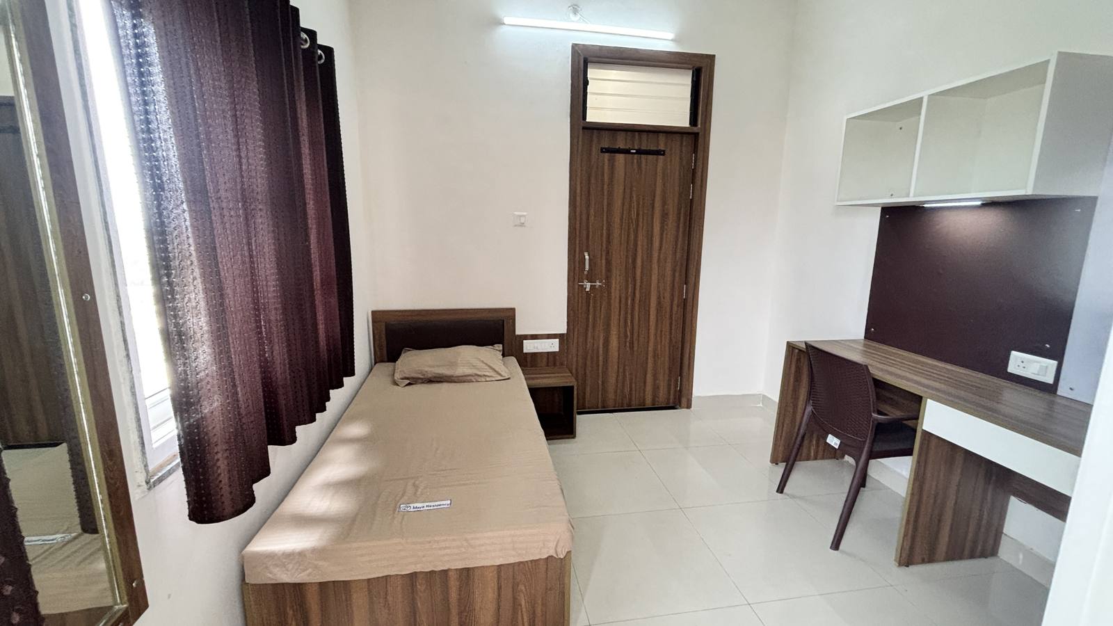 Maya Residency Coral Park single room with bed and study desk